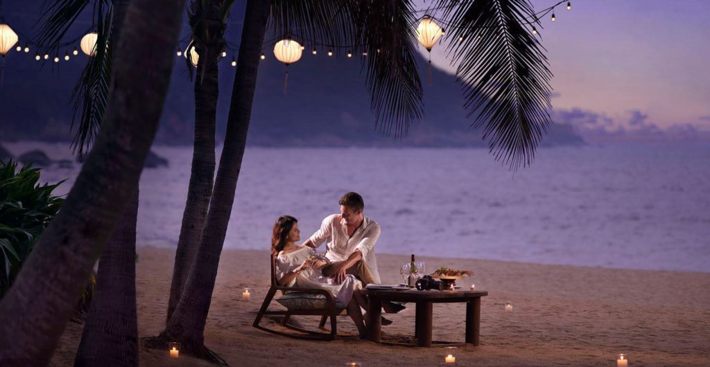 Couple dining at night on the beach