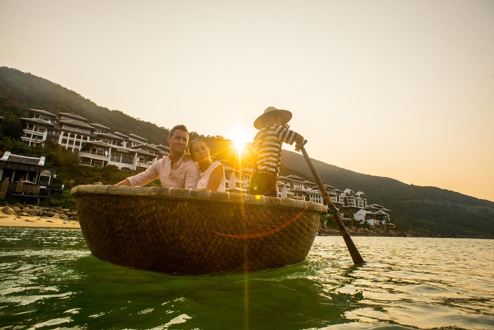 Couple on a ride in a basket boat with staff person rowing