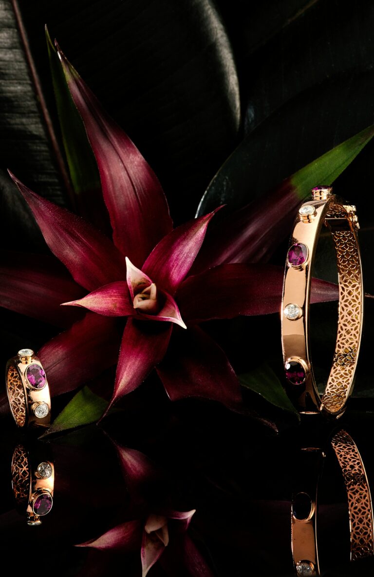 The Amaranthine Dioamond collection of kate mccoy with a jungle flower background