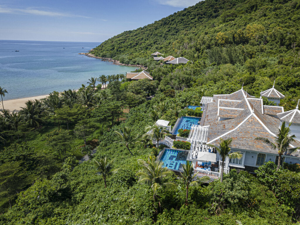 Aerial view of villa with ocean and beach in background