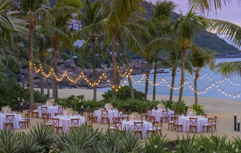 Beach dining set up with fairy lights at sunset